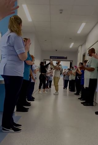 Hospital staff gathered to cheer the little girl on