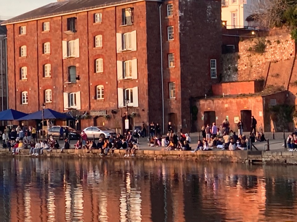 People basked in the sunshine yesterday in groups of more than three along the river in Exeter