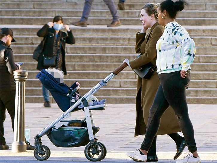 The PM's girlfriend pushes baby Wilf in a pram around Westminster