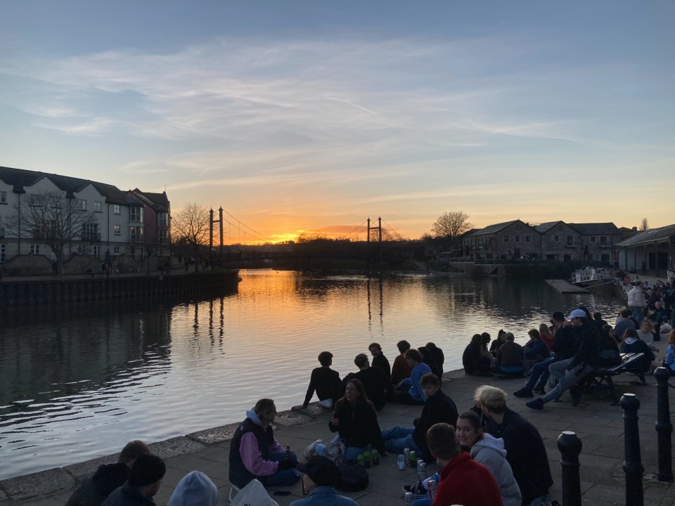 Crowds along the River Exe enjoyed the warm temperatures