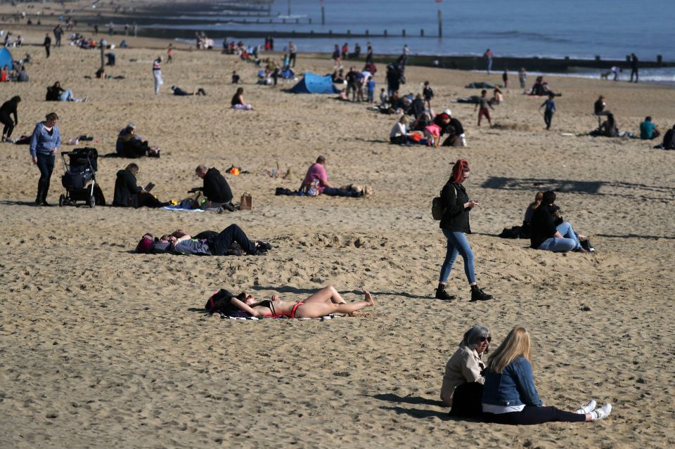 Sunbathers keep to social distancing measures while out at Bournemouth beach in Dorset