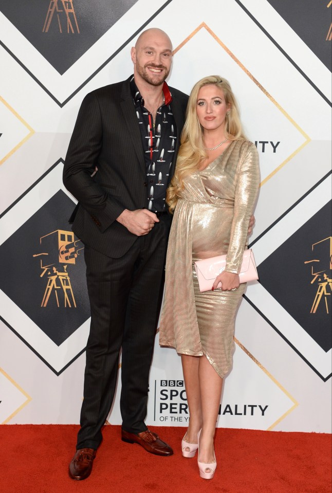 a man and a woman pose on a red carpet that says bbc sports personality of the year