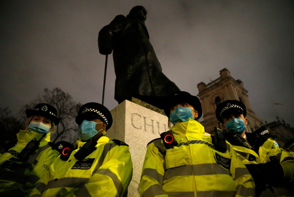 Cops protect the Churchill statue in Parliament Square last night