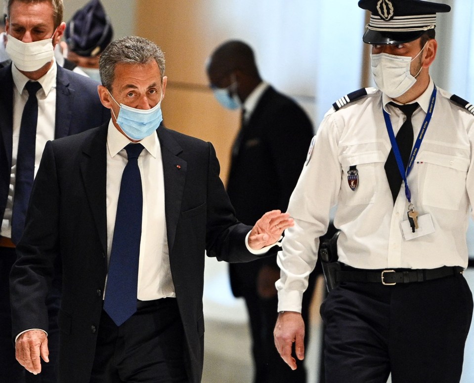 Sarkozy arriving at the Paris court house today