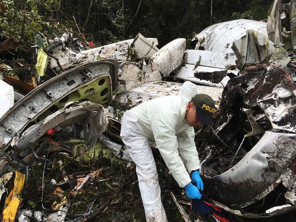 Police officers check the wreckage of the plane from 2016