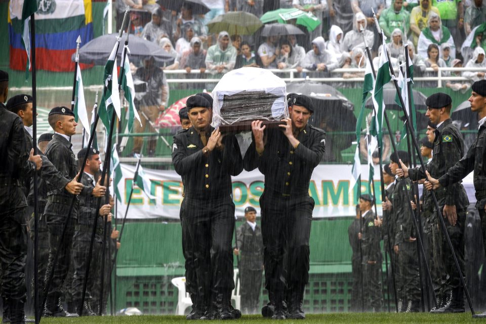 Members of the Brazilian Army carry the coffins of Chapecoense  team during a funeral ceremony at the club's stadium in December 2016.