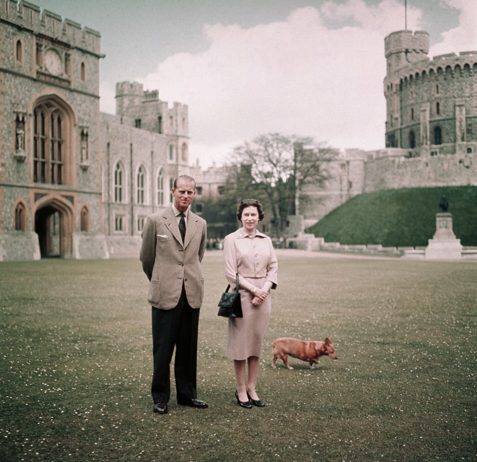 Prince Philip is seen here with the Queen and one of her pet dogs at Windsor