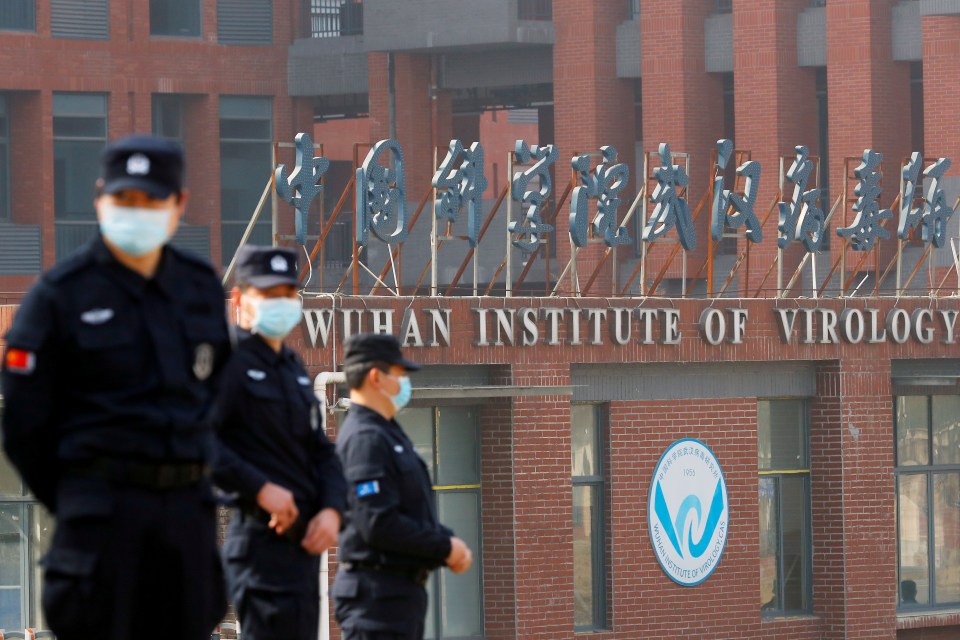 Security guards stand outside the Wuhan Institute of Virology