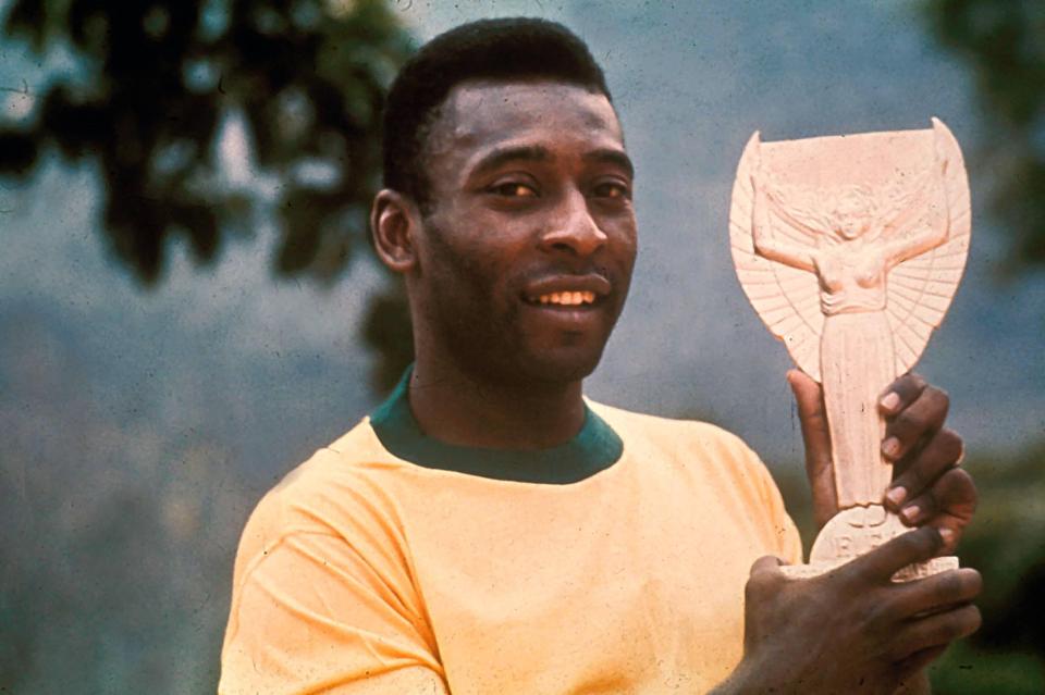 Pele holds aloft the Jules Rimet trophy after helping Brazil win the 1970 World Cup