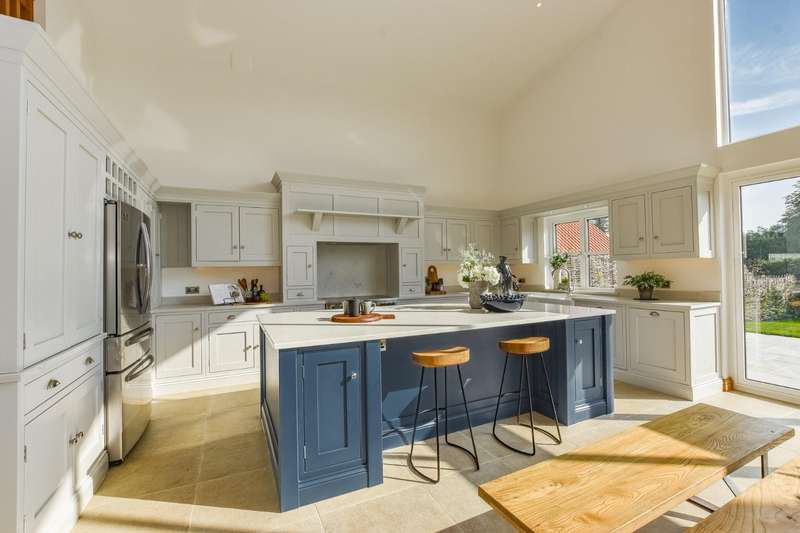 The space boasts grey cupboards, matching worktops and a gorgeous view of the massive garden