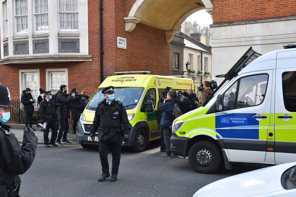 Members of the press stood by as an ambulance left the hospital this morning