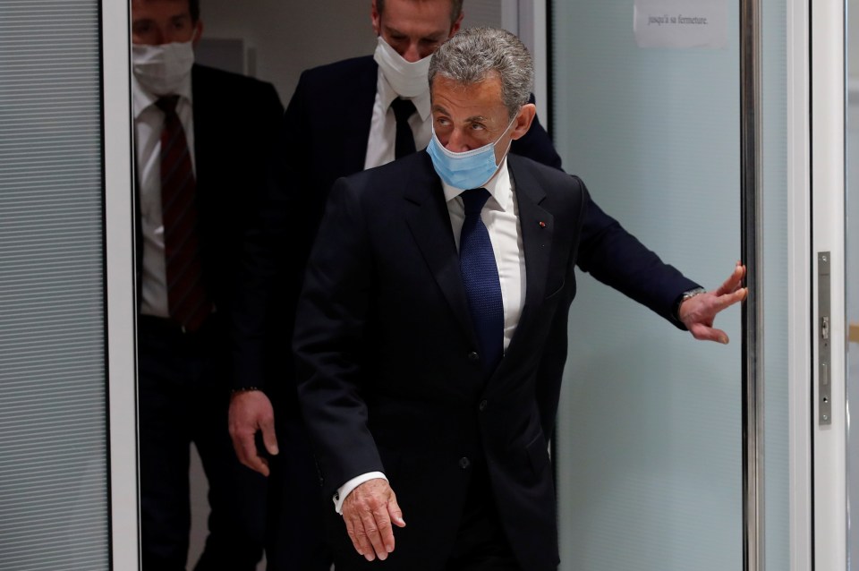 Nicolas Sarkozy, wearing a protective face mask, leaves after the verdict today