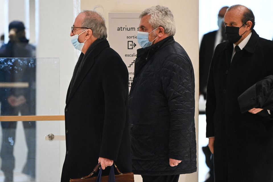 French Lawyer Paul-Albert Iweins, left, walks in front of his client lawyer Thierry Herzog