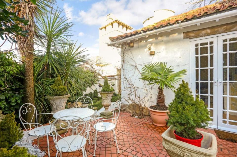 There is a dining area and conservatory overlooking the courtyard garden