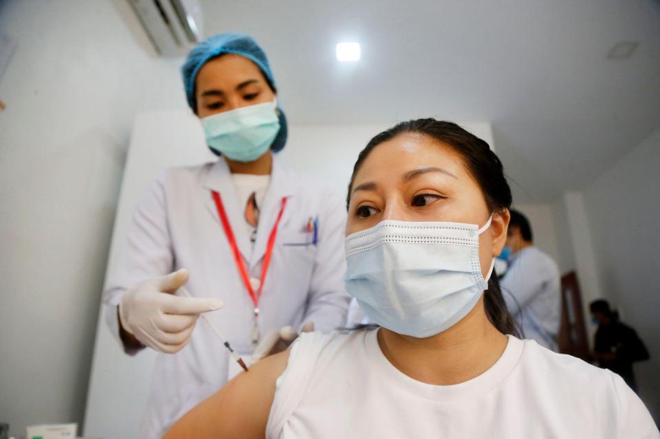 A hospital nurse gets a shot of a Chinese-made Sinopharm vaccine in Phnom Penh, Cambodia