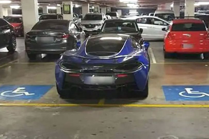 The driver of this McLaren 570GT parked across two disabled bays in Melbourne