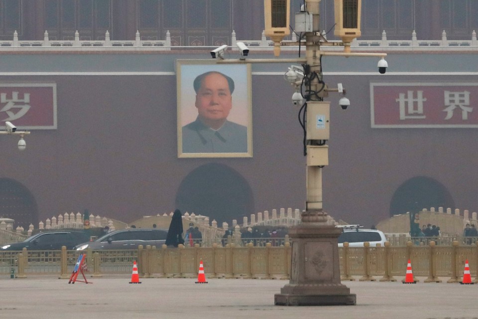 Surveillance cameras are seen in front of the portrait of late Chinese chairman Mao Zedong on Tienanmen Gate