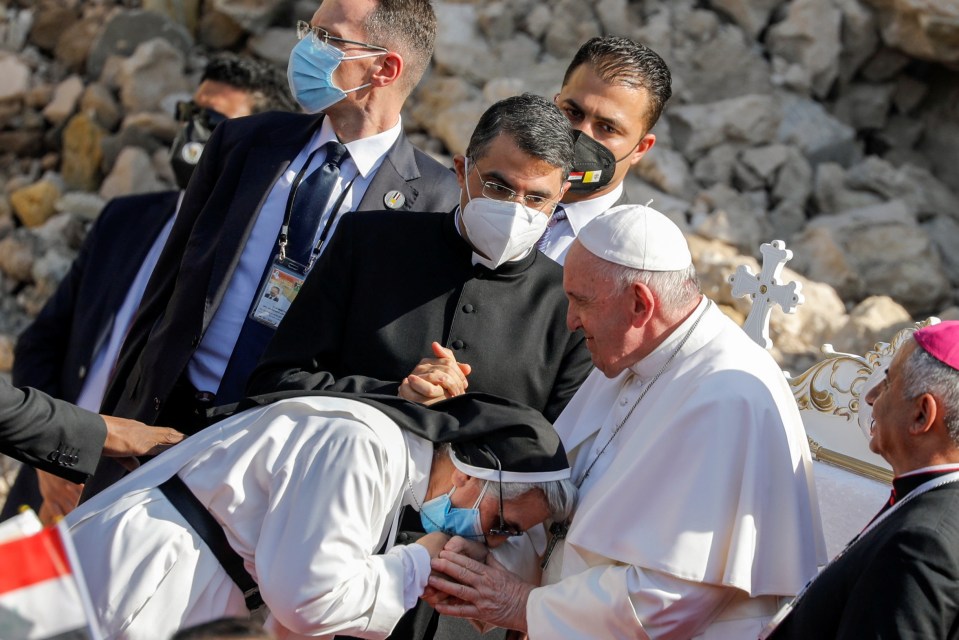 A nun greets Francis during a prayer for war victims in the destroyed Iraqi city