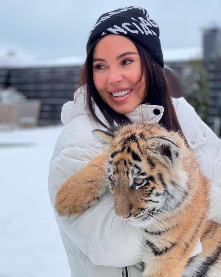 Oxana Samoylova, wife of rap singer Geegun, has been slammed after posing with a tiger cub