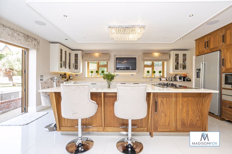 The open plan living area has a huge kitchen island with bar stools and even a breakfast booth