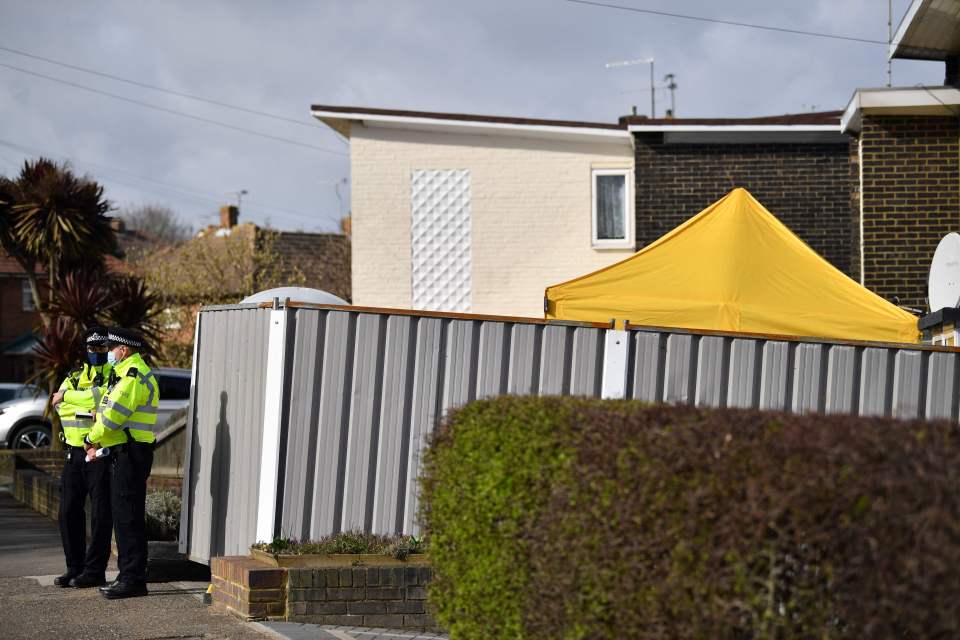 Police stand guard at a home in Kent as officers look for more clues