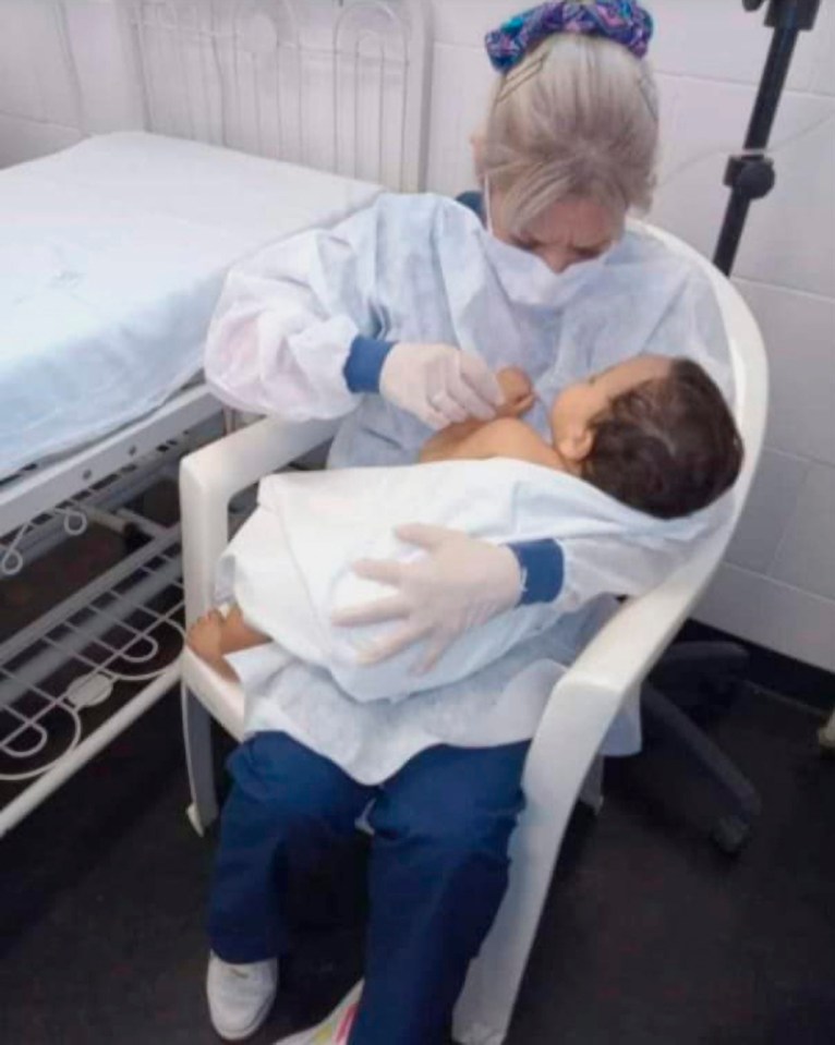 The 11-month-old baby being cradled by a nurse is now orphaned