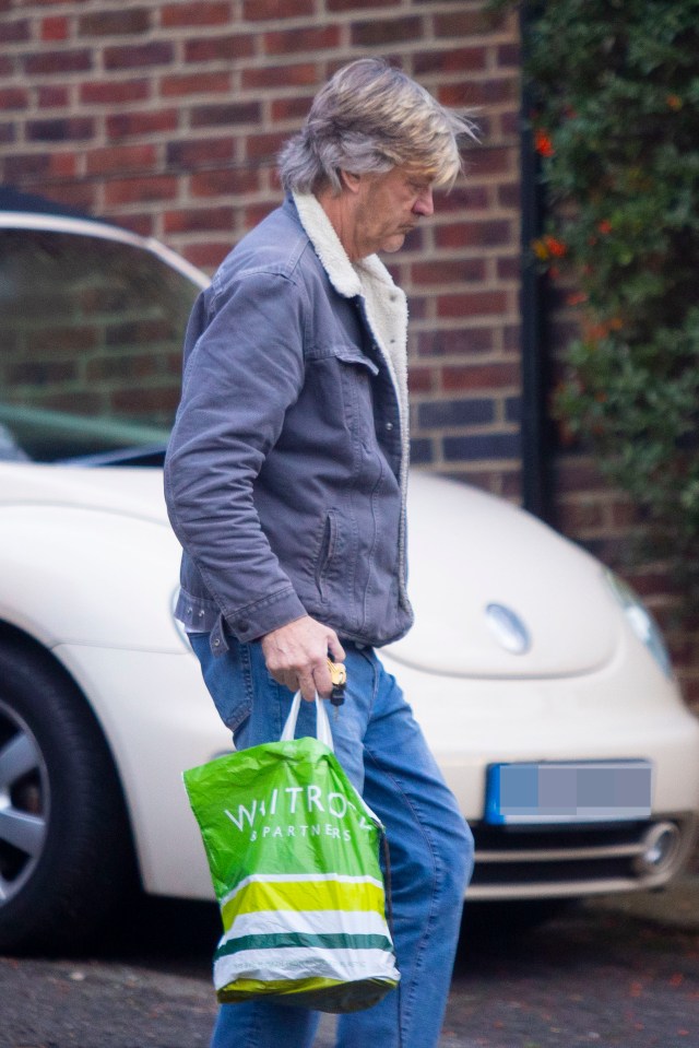 Richard kept his head down as he took the bags into his house