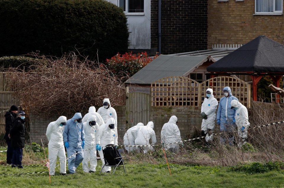 Forensic officers are seen searching near a property in Deal, Kent