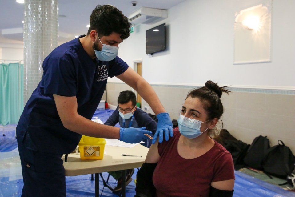 A woman receives the Oxford AstraZeneca vaccine in Haringey, north London