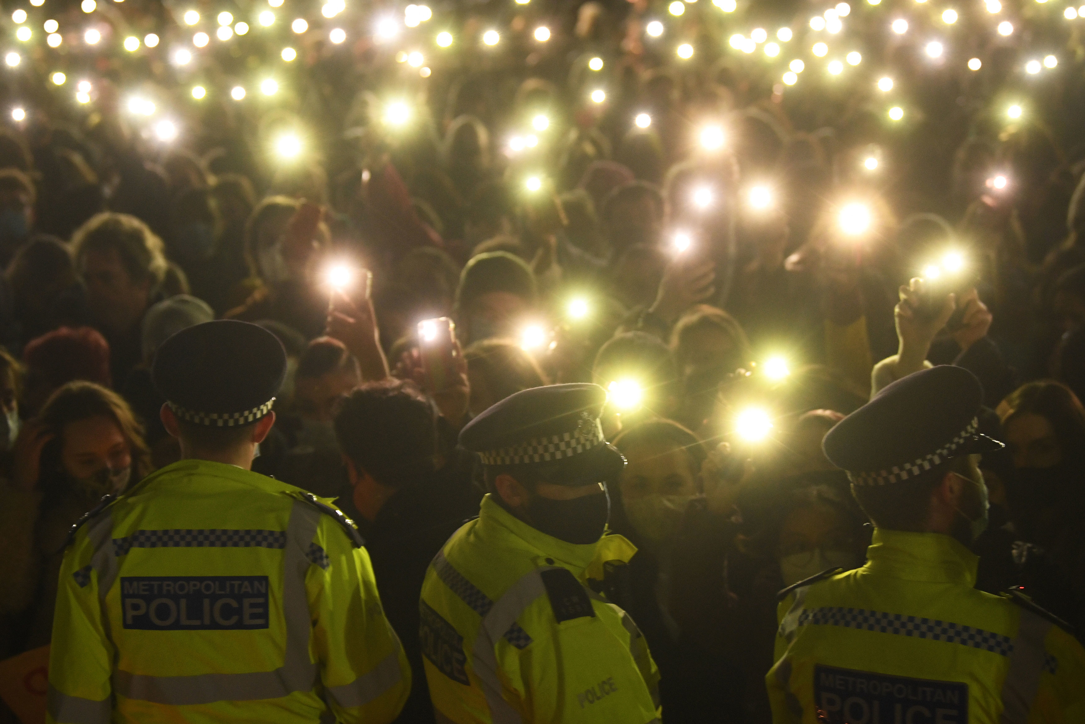 Mourners shone lights as police barricaded the Common bandstand