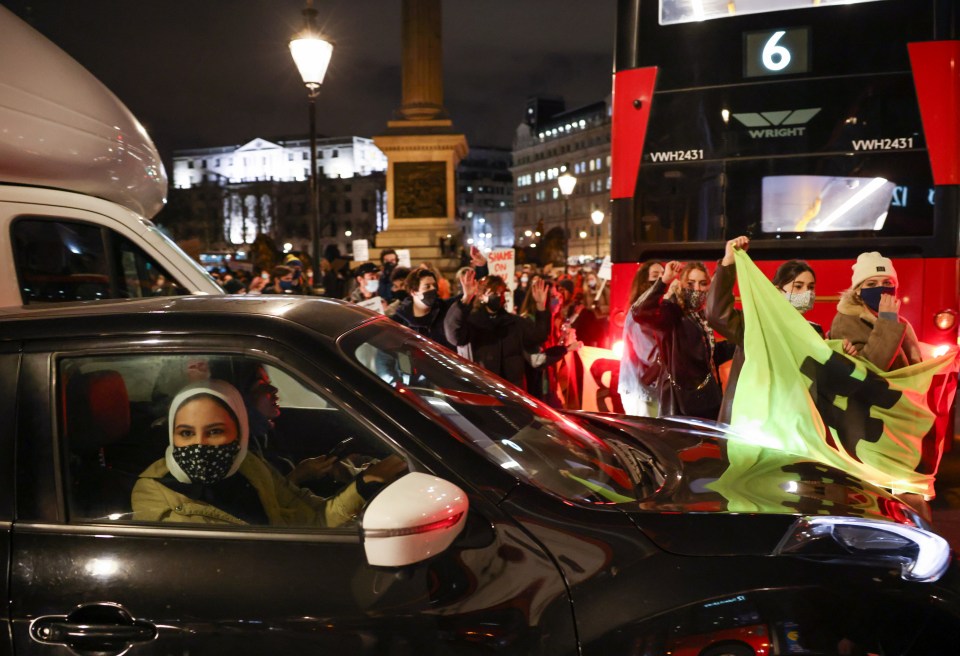 People participate in a protest at Trafalgar Square