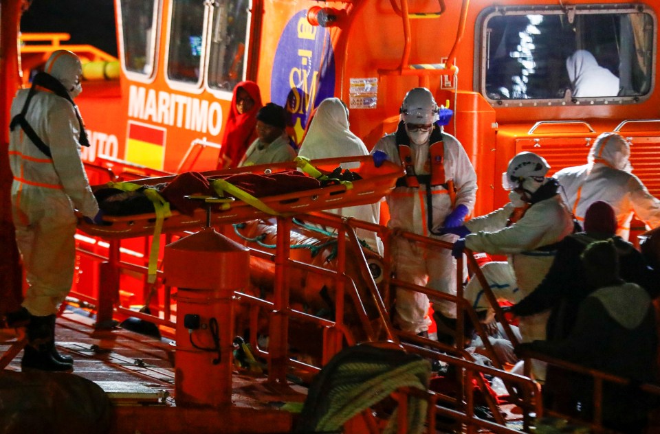 Medics bring the sickest migrants ashore from a Coast Guard ship