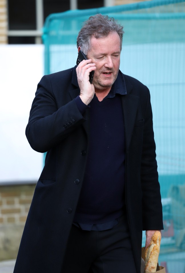 Piers talked intently on the phone during his outing