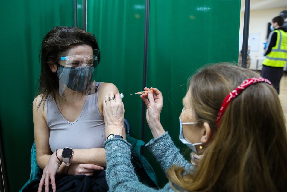 A woman is given a Covid jab at Finsbury Park Mosque, in Islington, north London