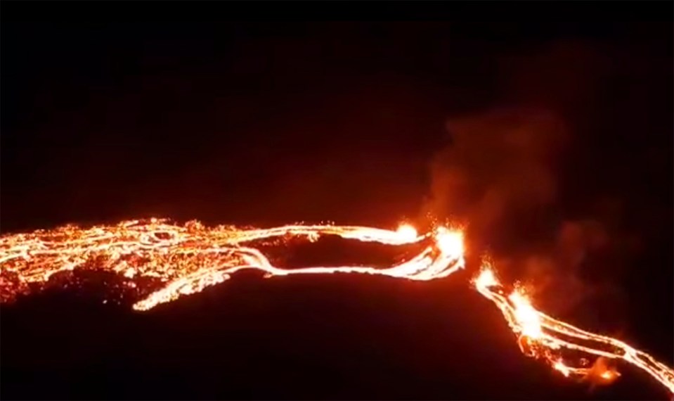 Aerial photos show a 200-metre crack containing molten lava forming at the eruption site