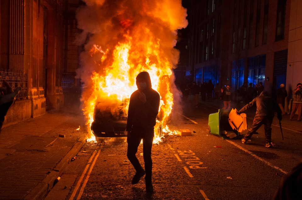 Protestors set fire to police vans during riots in Bristol last night