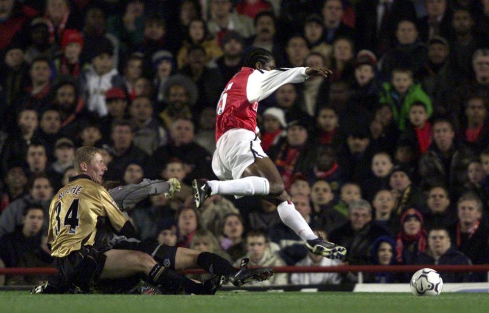 Roche, up against Arsenal striker Kanu, couldn't believe the size of his opponents feet