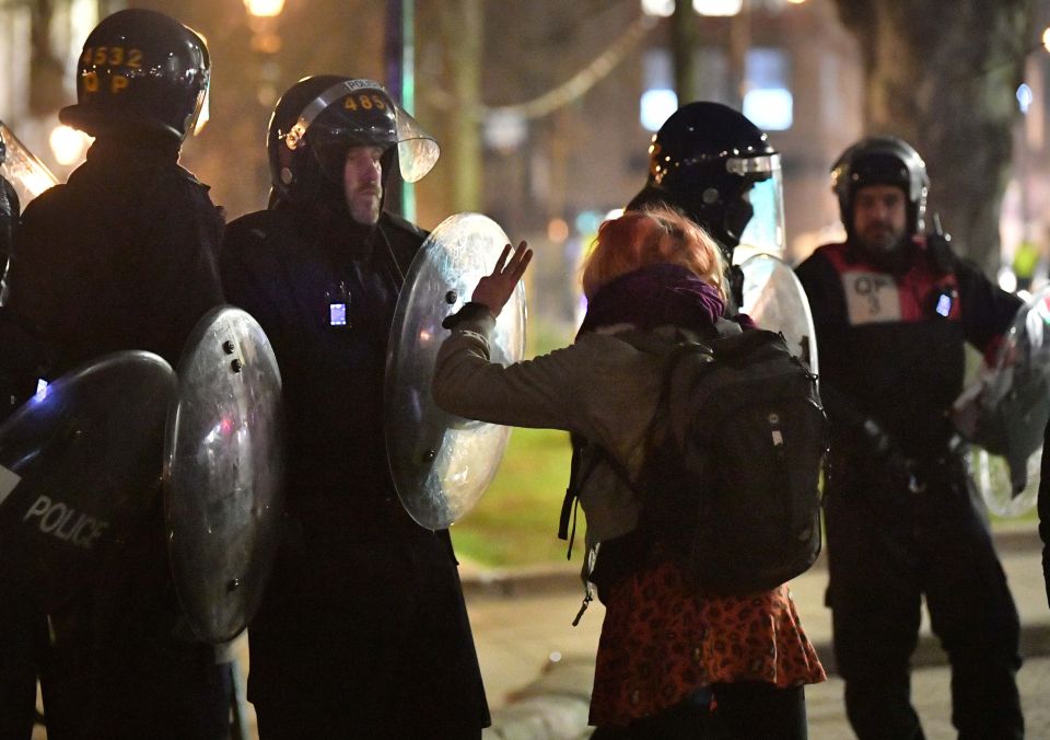 A woman speaks to riot officers at the protest in Bristol