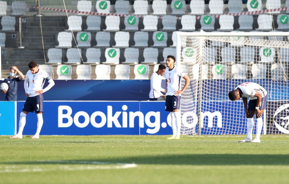 Ben Godfrey, left, Lloyd Kelly and Ryan Sessegnon, right, show their dejection at the final whistle after another flop tournament display by England U-21s