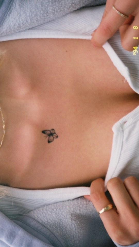 Nicola also showed off her dainty butterfly tattoo on her chest