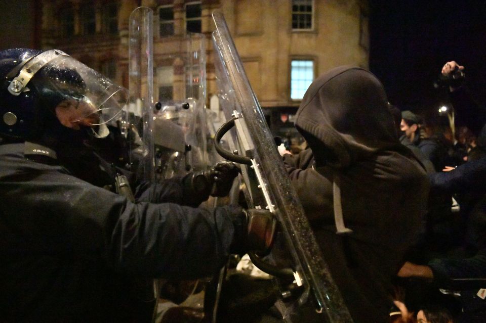 Police officers move in on demonstrators in Bridewell Street