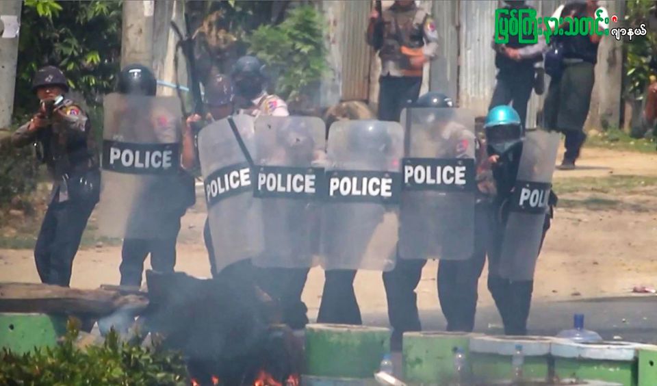 Police advance on protesters during a crackdown by security forces on a demonstration