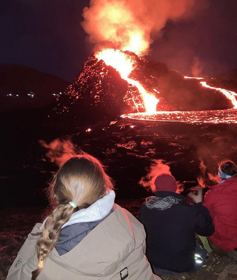 Tourists take photos of the volcano