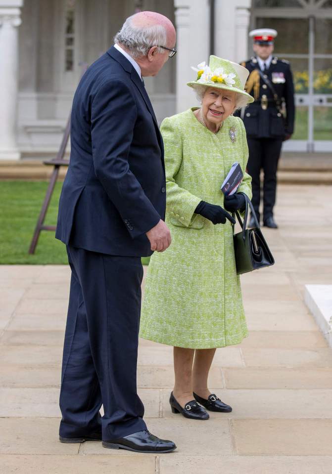 The Queen wore a green and ivory dress and jacket by Angela Kelly with a matching hat