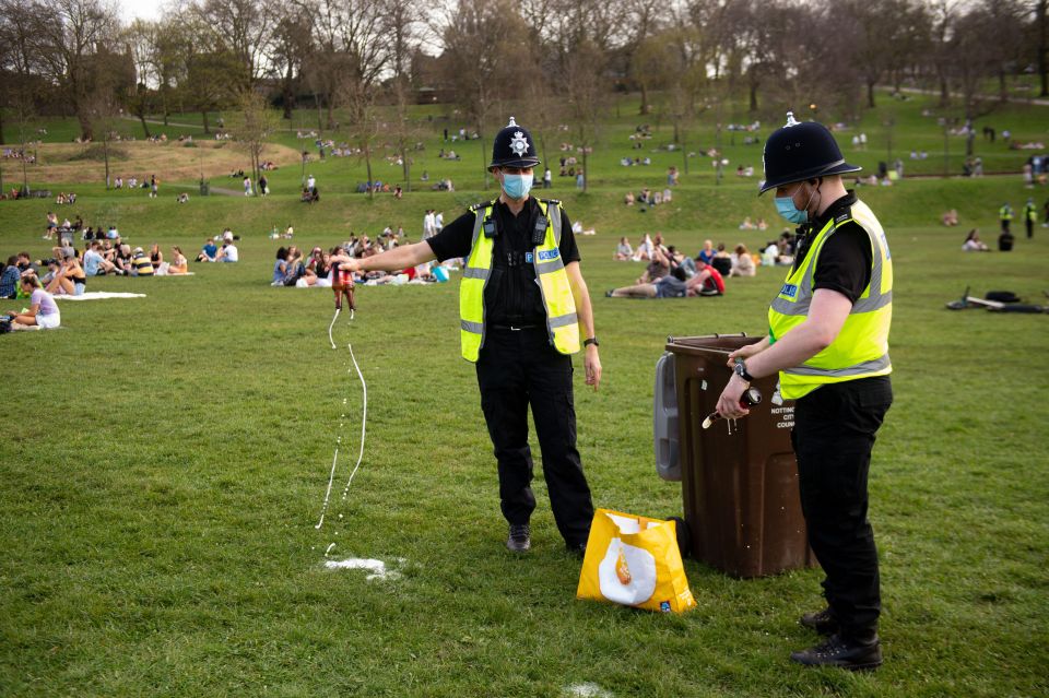 Police officers confiscate alcohol at the Forest Recreation Ground in Nottingham