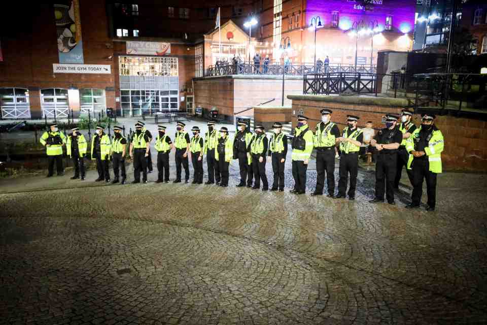 Cops broke up the city centre rave in Manchester with reports of glass bottles thrown at officers