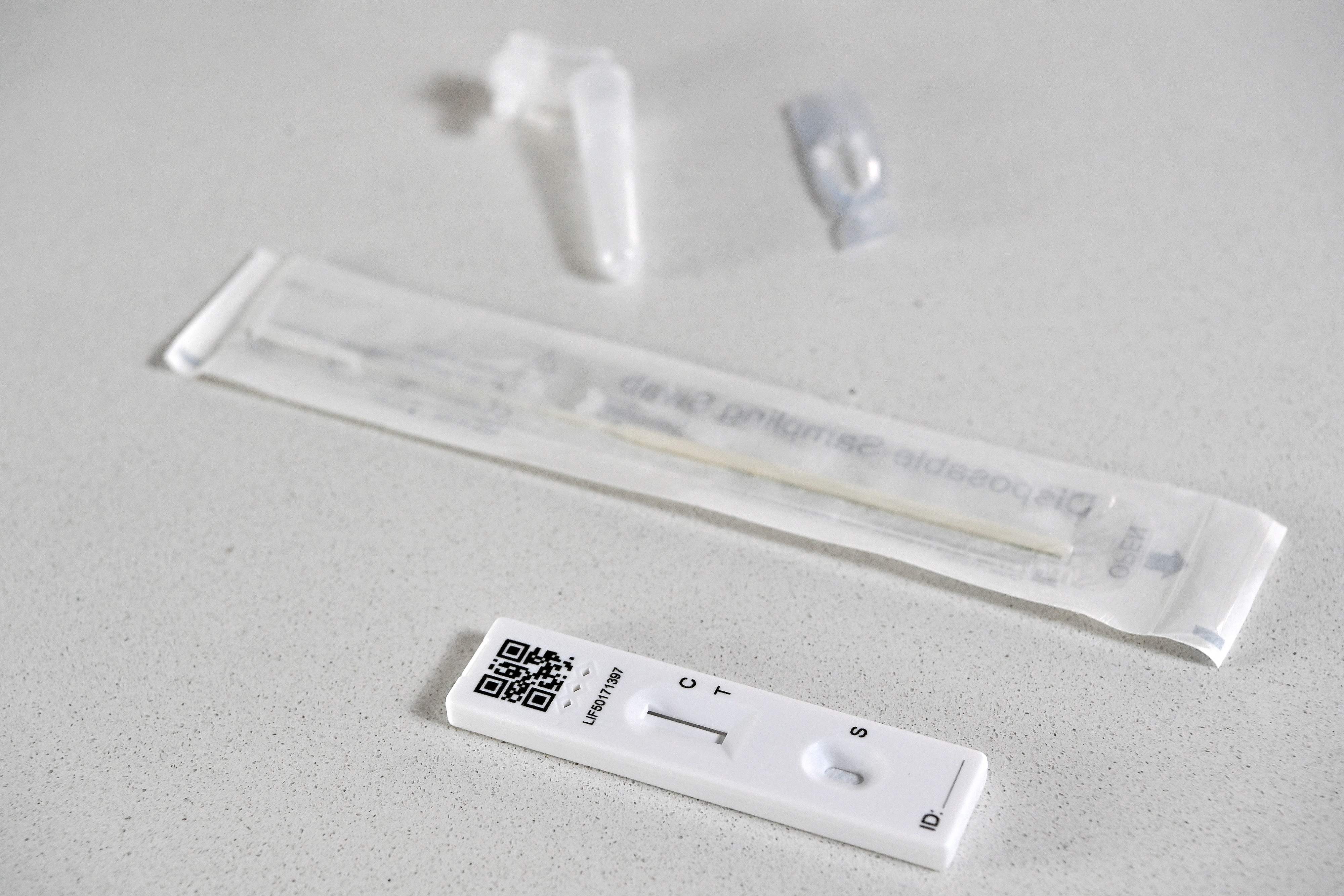 A Covid lateral flow test with the swab and pad device - Brits have been told to keep using these before meeting others or going to events