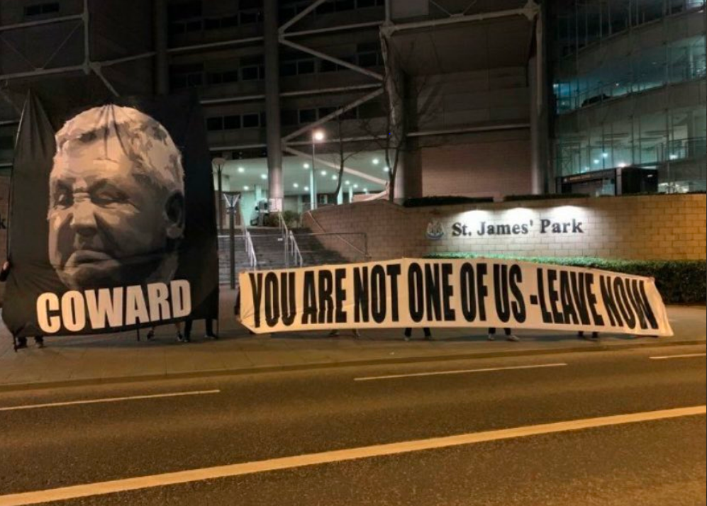 Newcastle fans held a banner outside St Jamesâ Park calling manager Steve Bruce a âcowardâ