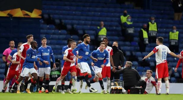 Connor Goldson runs after Ondrej Kudela on an explosive night at Ibrox