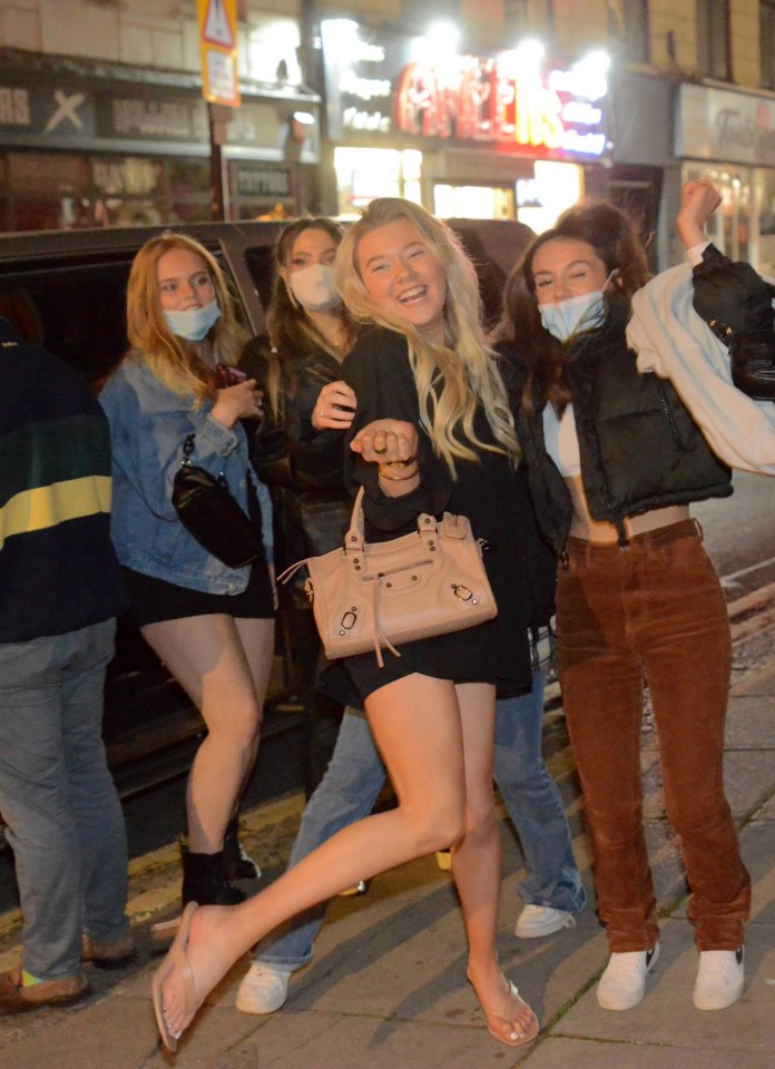 Masked-up pals enjoy a night out in freedom